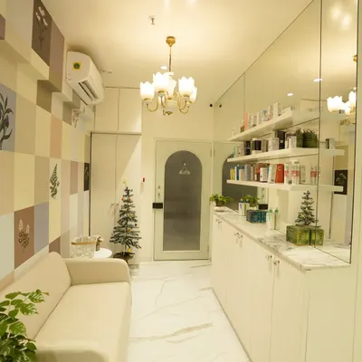 A view of our clinic's interior. We've created a clean, bright, and calming space where you can relax before your appointment. The mirrored wall reflects our extensive range of dermatologist-approved skincare products.