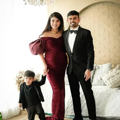 A classic family maternity portrait in our studio. The rich velvet gown and formal attire create a look of timeless elegance as this family of three prepares to become four.