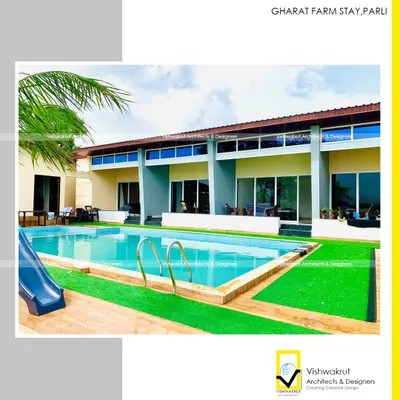 A view of the completed Gharat Farm Stay pool, complete with a water slide. This feature was designed to make the resort family-friendly, adding an element of fun to the serene natural environment.
