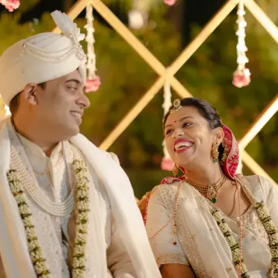 A candid moment of pure joy between the couple during their wedding ceremony. It's these unposed smiles that tell the real story.