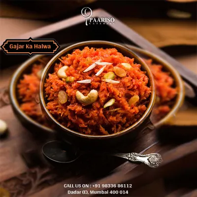A close-up of our homemade Gajar Ka Halwa, a traditional winter dessert. It's made by slow-cooking grated carrots in milk and ghee, and garnished with cashews, almonds, and raisins.