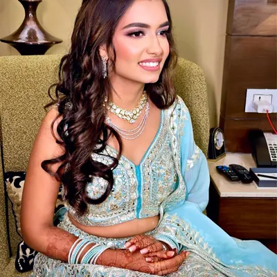 The perfect soft glam for a reception. This look features a dewy, flawless base, softly defined eyes, and a natural lip color, letting her beautiful smile and stunning lehenga shine.