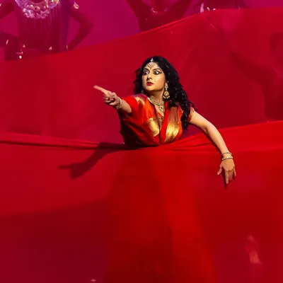 A dramatic moment from our production of 'Krishnaa', where I portray Draupadi. The use of a simple prop like this vast red cloth can create powerful, symbolic imagery on stage, telling a story of turmoil and emotion.