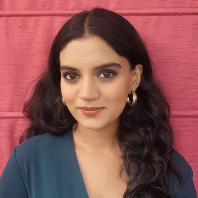 A modern and formal makeup look suitable for an evening reception or party. This style features a blended green smokey eye with a defined lower lash line and a glossy nude-brown lip, creating a sophisticated and glamorous effect.