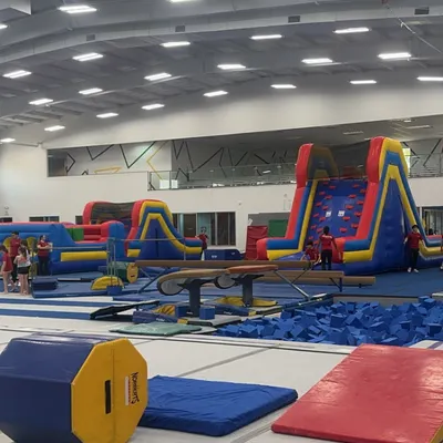 A look at our spacious facility, set up with inflatables, a foam pit, and gymnastics equipment for a day of fun and learning.