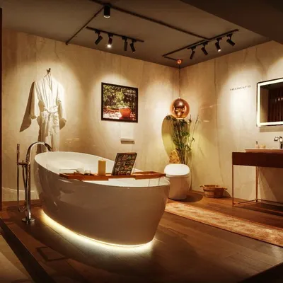 In this luxury bathroom showroom, my goal was to create a dramatic and aspirational mood. I used adjustable track spotlights to precisely highlight the bathtub and decor, while soft, indirect light from under the tub and behind the mirror adds a layer of warmth and sophistication.