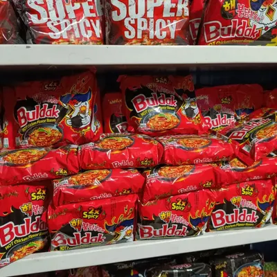 Shelves stocked with Samyang Buldak 2x Spicy Hot Chicken Flavor Ramen. This is a very popular Korean instant noodle for those who love extreme spice.
