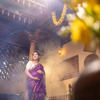 A truly magical maternity shot. The rays of light streaming from above and the soft smoke create a divine, ethereal atmosphere, celebrating the miracle of new life.