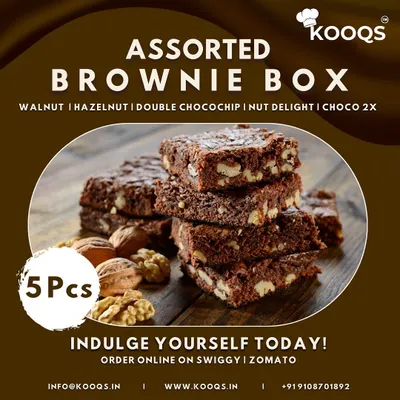 A close up of our Assorted Brownie Box, featuring a stack of rich, fudgy walnut brownies. Each box includes five different varieties, such as hazelnut and double chocochip, making it a perfect dessert to order online for yourself or as a gift.