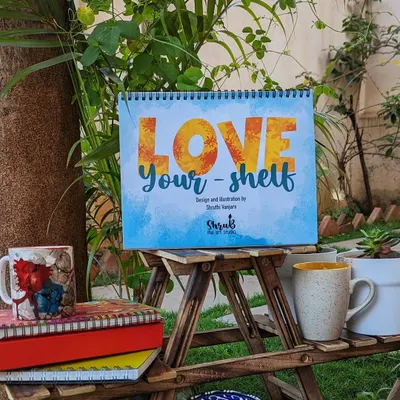 The cover of my 2023 desk calendar, 'Love Your-shelf'. The theme celebrates the little things we collect that bring us joy, from books to plants.