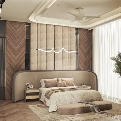 Luxury meets calm in this master bedroom retreat. I used a curved, upholstered headboard that extends along the wall, complemented by chevron-patterned wood paneling and a modern, sculptural light fixture.