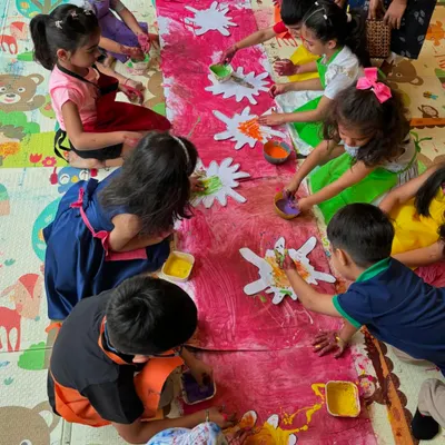 Here's an overhead view of one of our giant group paintings in progress. I lay out a long canvas on the floor so all the kids can gather around and contribute to one big, beautiful, messy artwork.