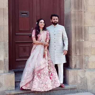 A perfect pair ready for their wedding day. The bride's soft pink look and the groom's elegant sherwani create a timeless portrait.