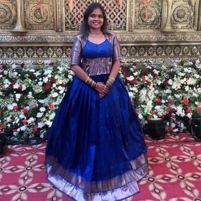 For Shravya's reception, we created this entire peplum blouse and lehenga set in just one day. The peplum top is made from a contrasting fabric for a modern look.