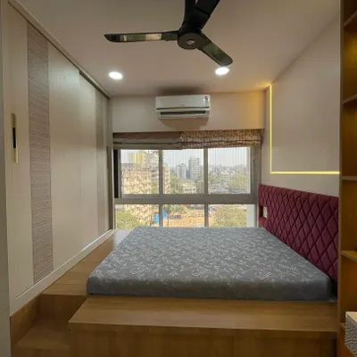 A perfect example of a dreamy and functional kids' bedroom. The elevated platform bed not only saves space but also creates a cozy, den-like feel, while the built-in wardrobe offers ample storage.