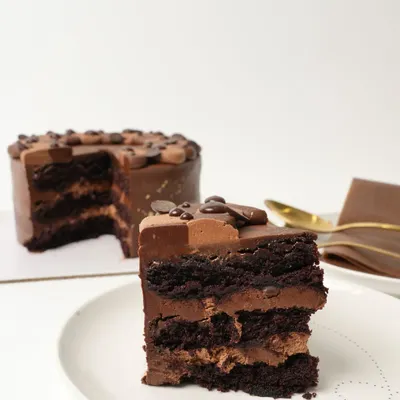 My most-loved Belgian Chocolate Mousse Cake. It is made with moist layers of chocolate sponge, chocolate chips, and a light-as-air chocolate mousse, all covered in a rich Belgian chocolate ganache.