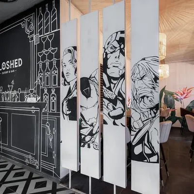 We designed this space to feel like stepping into a two-dimensional sketch. The monochromatic palette, geometric patterns, and comic-style art create an immersive and playful environment.