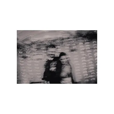 An artistic black and white photo using slow shutter speed. This creative shot captures the movement and emotion of the couple during their reception celebration.