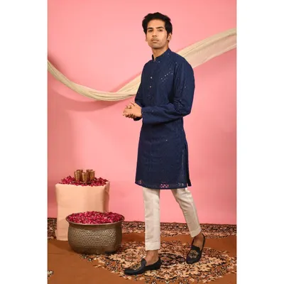 My navy blue chikankari kurta, shown here as a complete outfit. The classic silhouette is enhanced with all over embroidery and subtle mirror work, offering a timeless look for any festive occasion.