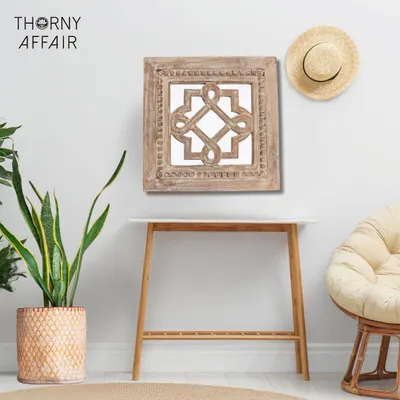 This handcrafted wall mirror, carved from mango wood with a rustic finish, adds a touch of natural charm to your wall. The intricate knot design makes it a unique piece of wall art.