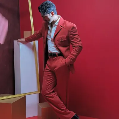A striking red suit designed for making a confident statement. The unique pocket details and sharp tailoring demonstrate our ability to blend classic structure with bold, modern style.