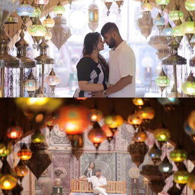A breathtaking shot of the couple surrounded by a ceiling of glowing Turkish lamps. This image showcases the magic of a themed set, creating a romantic and visually stunning portrait that feels like a scene from a fairytale.