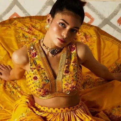 A captivating shot from a designer lookbook, where the makeup enhances the model's direct gaze. I used warm tones and a dewy finish to complement the rich yellow and intricate embroidery of the ensemble.