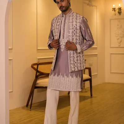 A full-length view of the lilac Indo-Western set, complete with a mirror-work jacket, matching kurta, and white trousers. This outfit is a perfect choice for a Sangeet or a destination wedding.