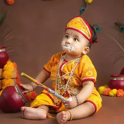 A baby dressed as little Krishna for a Janmashtami festival shoot, with a bit of "butter" on his face.