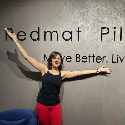 This is me, Taru, in my element. I am so proud of the joyful and empowering space we have created at RedMat Pilates, a place to move better and live better.