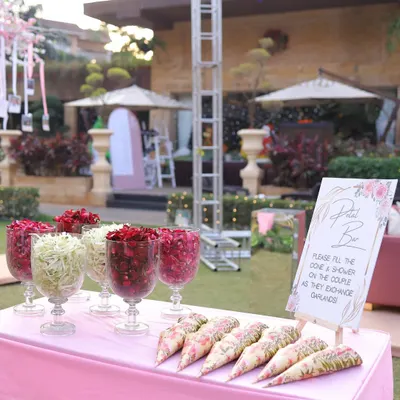 A 'Petal Bar' for guests to shower the couple with blessings as they exchange garlands. It's a small touch that involves guests in the ceremony.