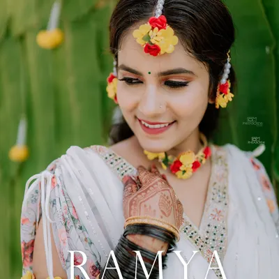 A beautiful close-up of the bride during her Haldi ceremony, adorned with fresh floral jewelry. We focus on capturing the bridal glow and intricate details.