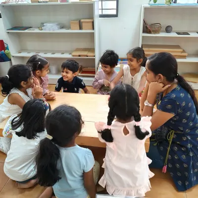 While individual learning is key, purposeful group time is also important. Here, children gather for circle time, learning to take turns, listen to their peers, and feel a sense of belonging.