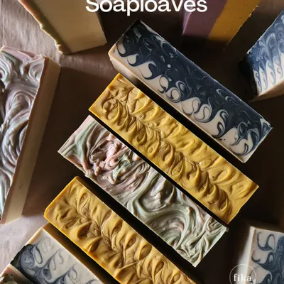 A beautiful collection of my finished soap loaves. You can see the variety of natural colors and intricate swirl patterns I create. These are ready to be cut into individual bars for my wholesale and private label partners.