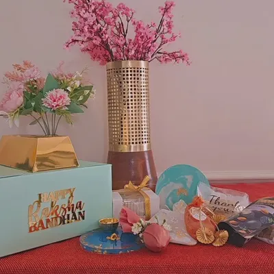 Announcing my exclusive, limited-edition Rakhi hamper boxes. This flat-lay shows a sample of what can be included, from artisanal candles and coasters to trinket trays and a resin thali.