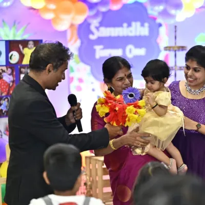 Magic is for everyone, even the littlest guests. Here, I'm performing a gentle flower magic trick for the one-year-old birthday girl, creating a sweet and memorable moment for her family.