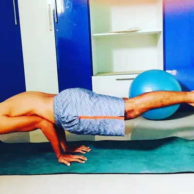 Core strength is the center of a player's power and stability. This image shows an advanced balancing exercise that builds the core and upper body strength essential for controlled, powerful shots on the court.