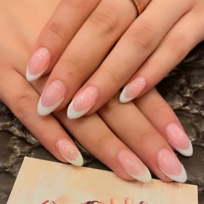The perfect classic French manicure on medium-length almond nails. This design features a clean, sheer pink base and crisp white tips for a timeless and elegant look.