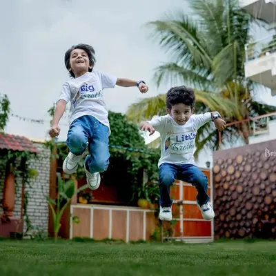 Double the giggles, double the grins! Capturing the boundless energy of these two brothers as they jump for joy during their outdoor kids photoshoot.
