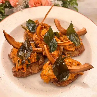 This is my Kerala Masala Arabi Chaap, a unique vegetarian appetizer. I pan-fry colocasia (arbi) morsels in A2 ghee and top them with a tangy onion relish, tempered coconut, and crispy curry leaves for a burst of flavor.