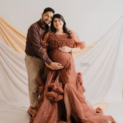 This stunning ruffled tulle gown in a warm rust color is a favorite from our client wardrobe, perfect for creating a rich, glamorous look.