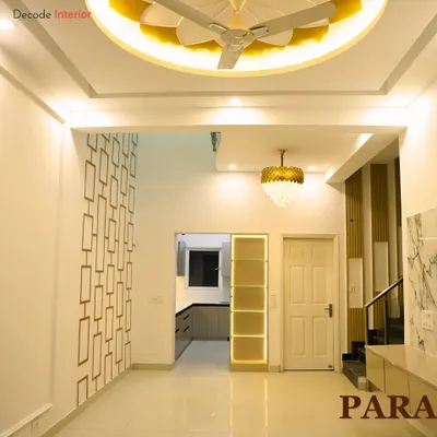 A glimpse into a royal-themed interior, showcasing a grand hallway with intricate wall patterns and a beautiful flower-shaped ceiling design.