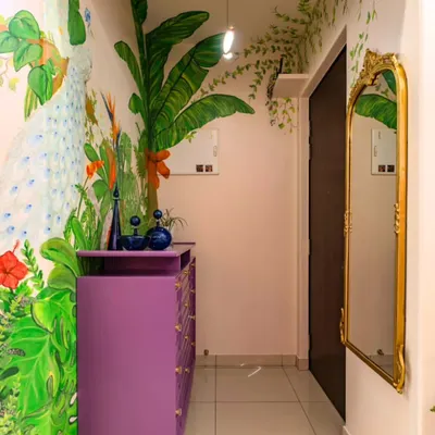 The foyer is the first chapter of a home's story. For this entrance, we painted a breathtaking mural featuring a peacock amidst lush jungle foliage. The vibrant colors and intricate details immediately draw you in and set a tone of artistic elegance.