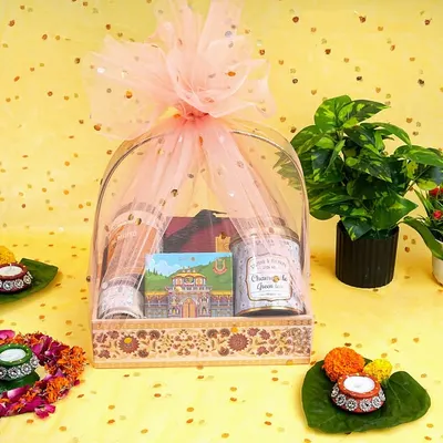 A beautifully styled shot of a festive gift hamper, complete with diyas and floral decorations. This type of photography is perfect for seasonal promotions and making your gift items look irresistible.