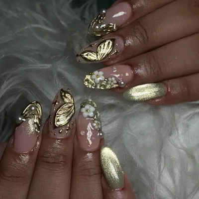 A truly unique set with 3D elements. I sculpted golden butterflies and small white flowers, pairing them with a gold cat eye accent nail for a magical vibe.