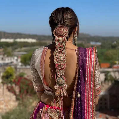 For this Mehndi look, I designed an intricate statement braid and adorned it with a stunning, oversized traditional hair accessory. This style is not only beautiful from the back but also practical for a long event.