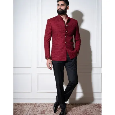 A full-length view of our crimson bandhgala set. The jacket's textured fabric and clean lines create a powerful statement, paired here with classic black trousers for a balanced and sophisticated formal look.