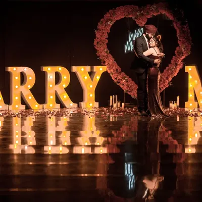 A grand proposal setup with "MARRY ME" marquee letters, creating a spectacular and unforgettable scene.