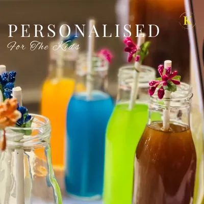 A colorful lineup of our personalized drinks for kids. Served in charming glass bottles with decorative floral straws, these fun beverages make children feel extra special at any celebration.