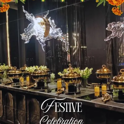 A festive buffet celebration setup, perfect for Rakhi or Diwali. The elegant arrangement features our signature brass chafing dishes, keeping dishes like Navratan Korma and Dal Makhani warm and ready for your guests to enjoy.